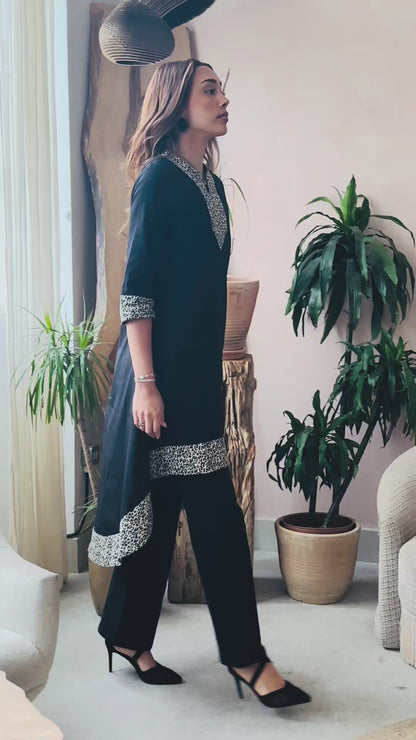 MAYA - Black dip hem dress with a touch of animal print